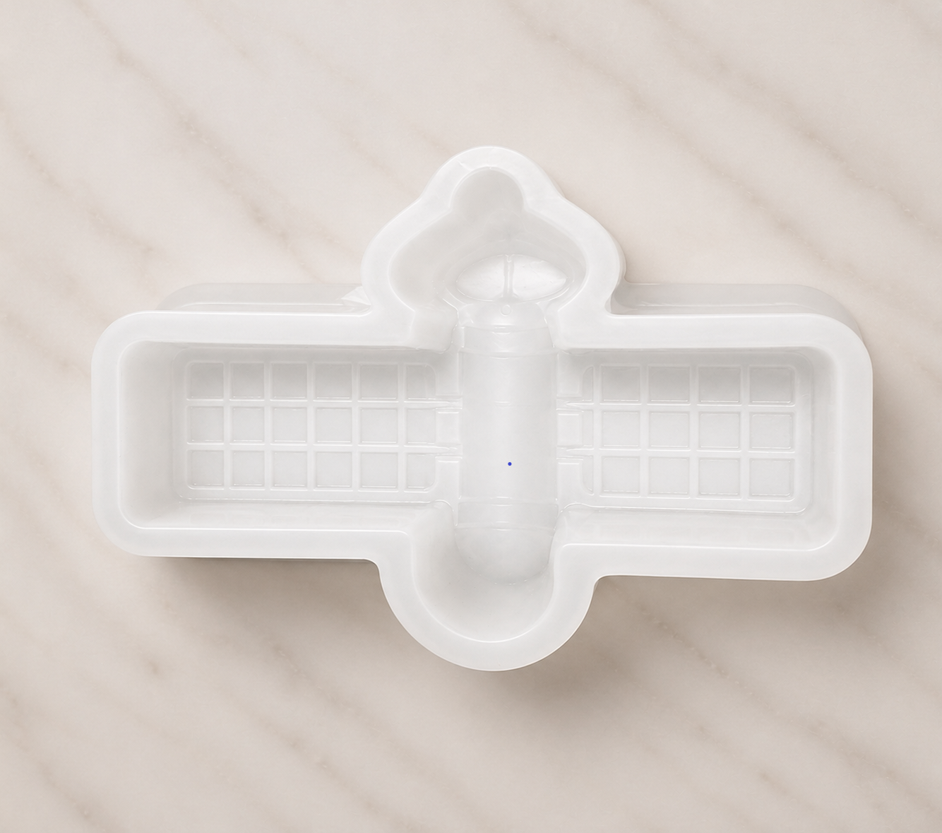 White plastic mold on a beige surface