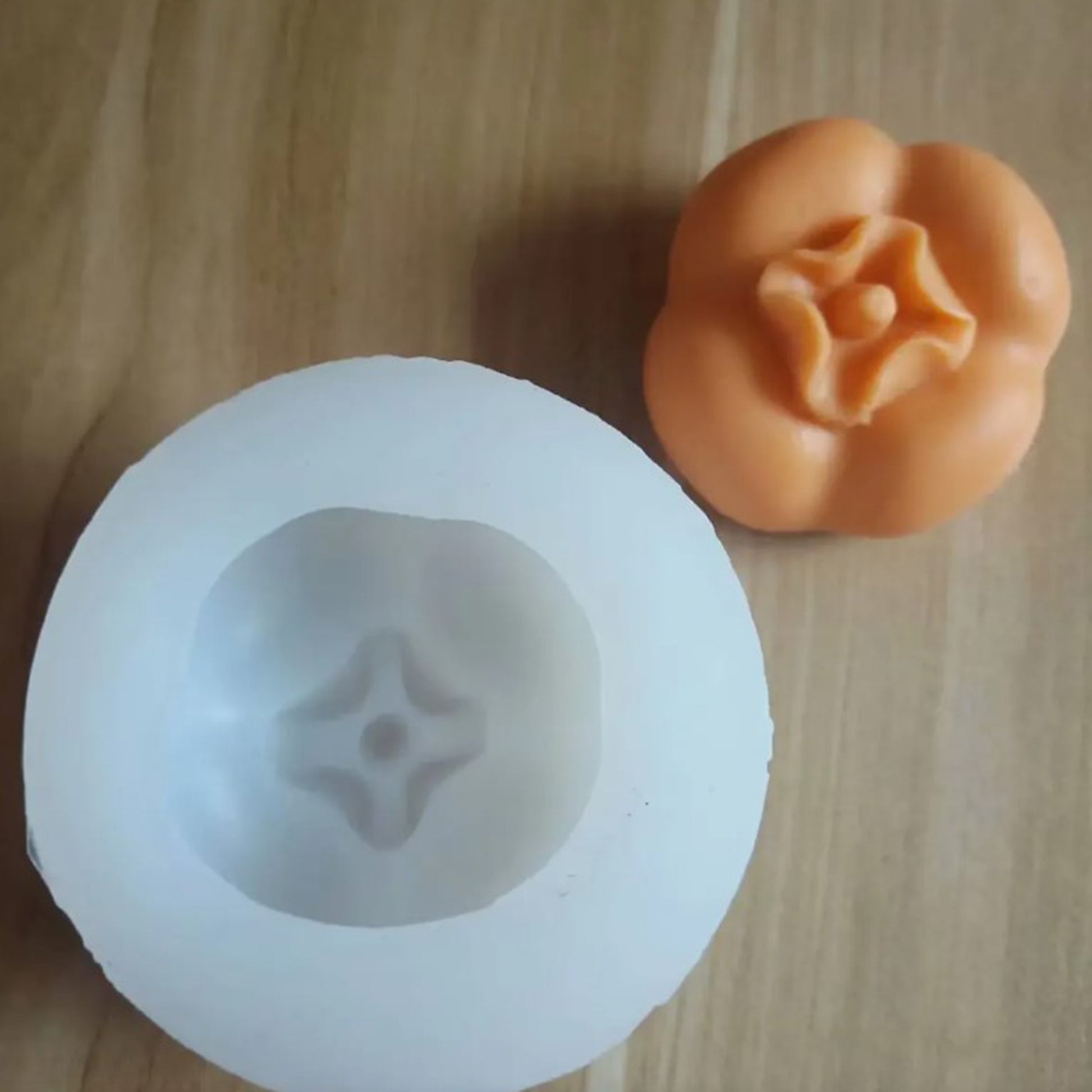 Silicone mold shaped like a pumpkin on a wooden surface