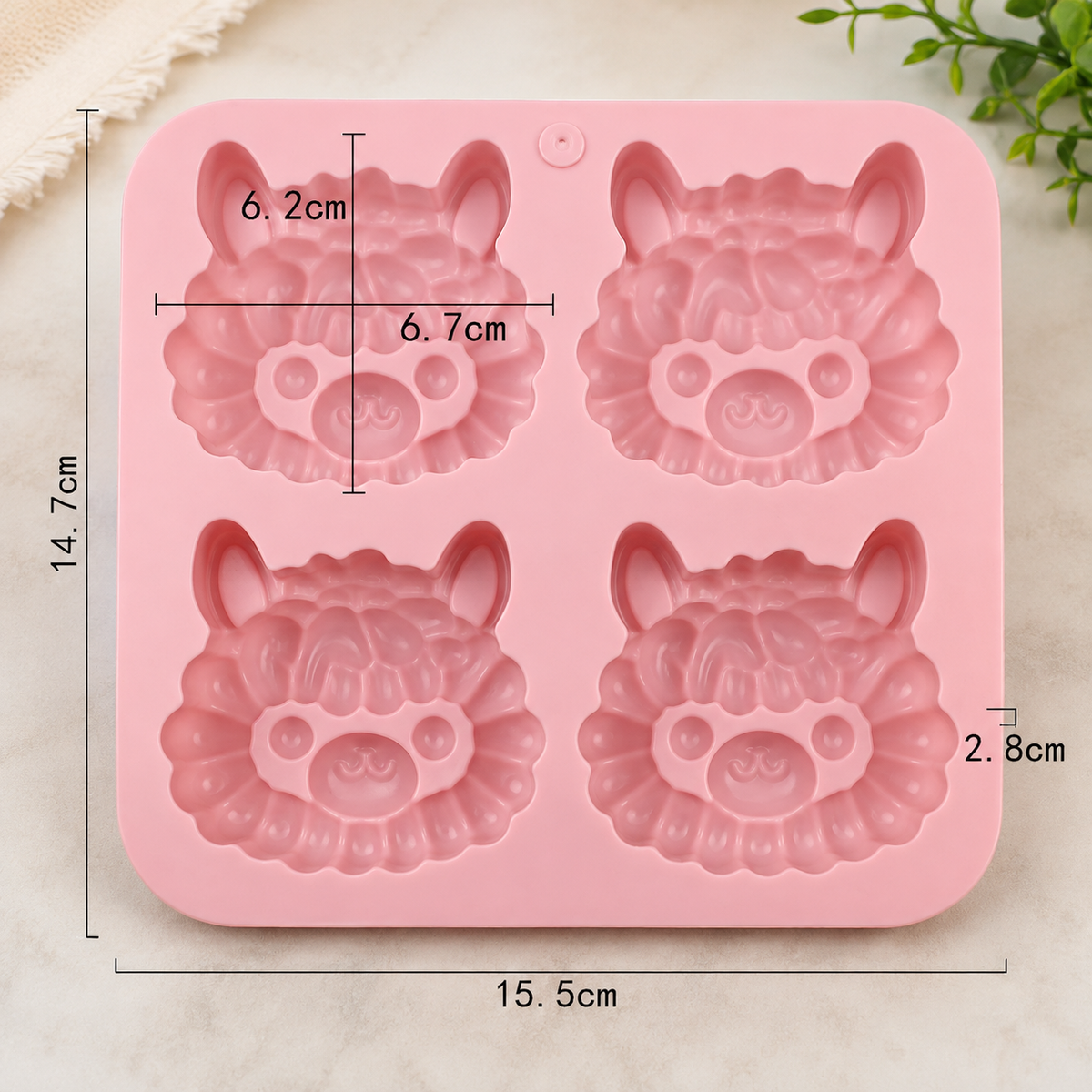 Pink silicone mold with four cartoon sheep faces, shown with printed dimensions (15.5cm by 14.