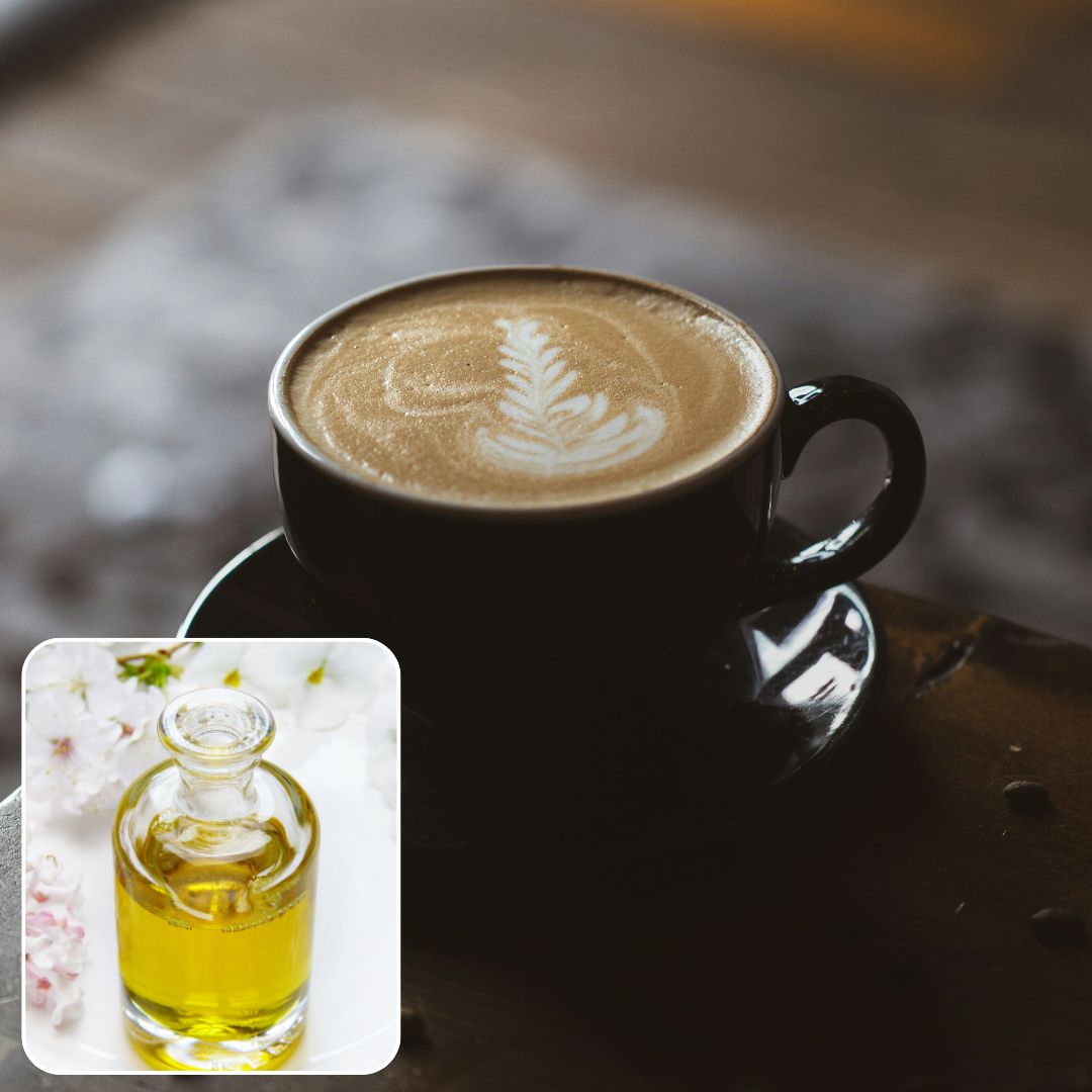Cappuccino with latte art on a wooden surface, inset with a bottle of oil.