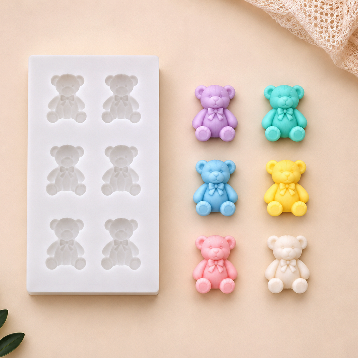  silicone mold for making teddy bears with colorful teddy bear candies on a beige background