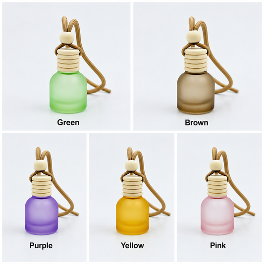 Five small glass bottles with wooden nozzles in green, brown, purple, yellow, and pink on a white background.