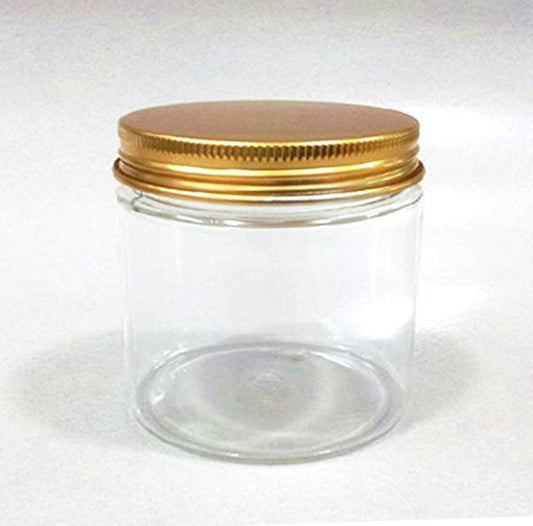 Clear glass jar with a gold metal lid on a white background