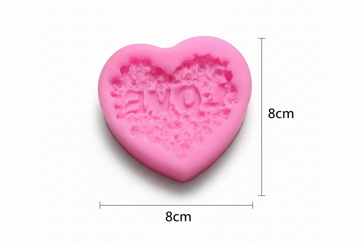 Heart-shaped pink silicone mold with 'MOM' text and measurements on a white background