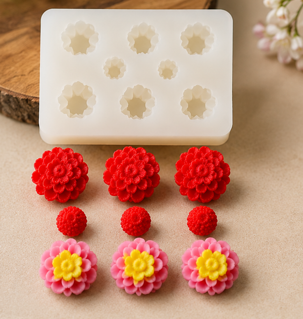 Silicone mold with flower shapes and corresponding flowers on a beige surface