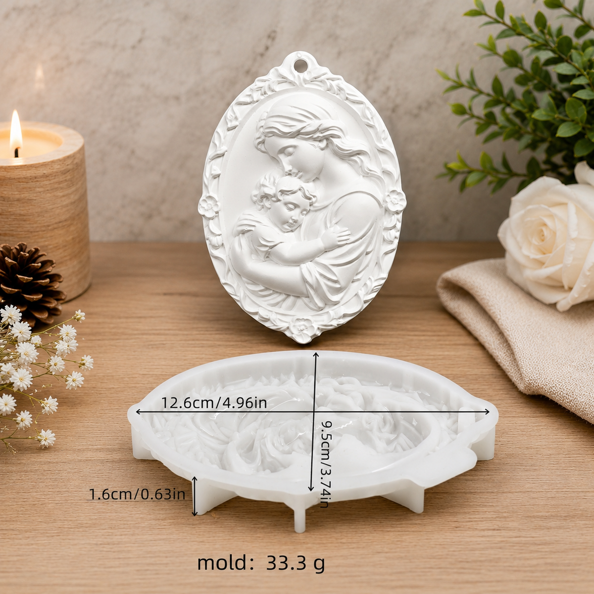 A white embossed jewelry mold shown on a wooden surface, with the lid placed above and the mold base below. Black measurement arrows and text indicate dimensions of the mold, including 12.
