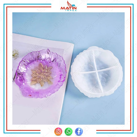 Two silicone molds with a floral design, one filled with purple resin to show the potential outcome of using the mold.