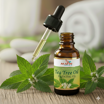 Bottle of Tea Tree Oil with dropper and leaves on a wooden surface