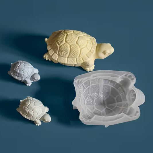 Turtle-shaped mold with three turtle models on a blue background