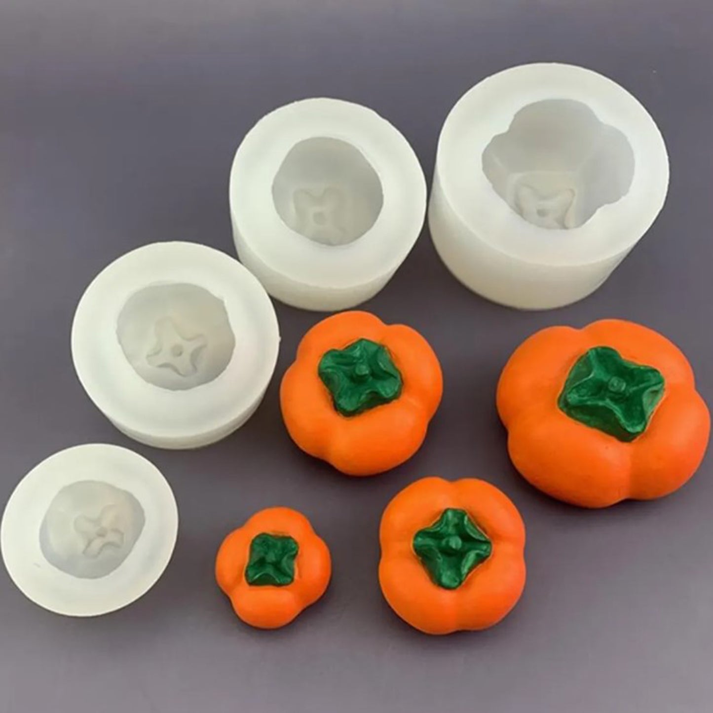 Silicone mold for making orange and green decorative items on a gray background