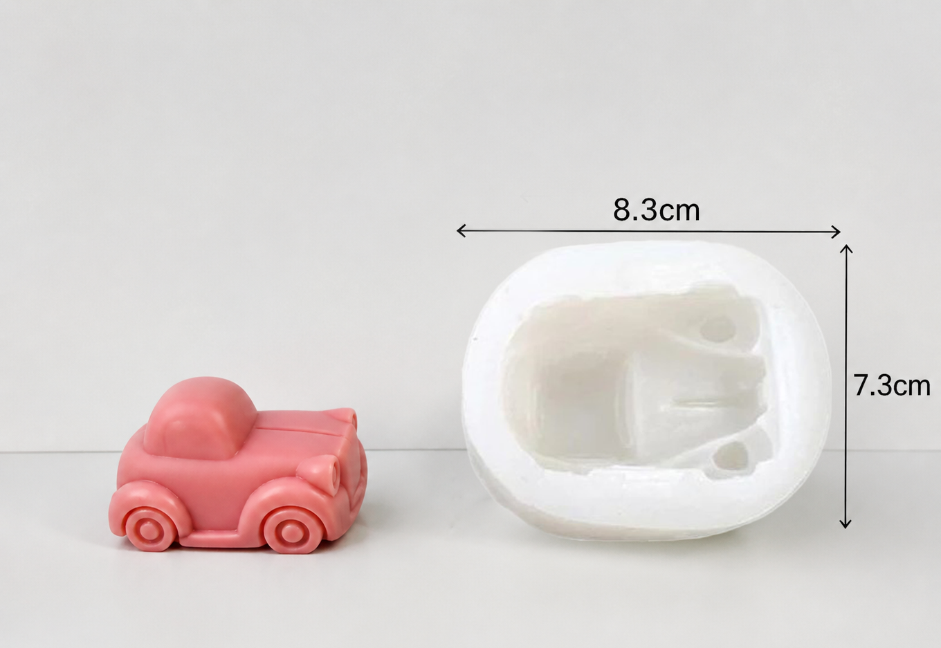 Pink car-shaped mold next to a white silicone mold with dimensions indicated.