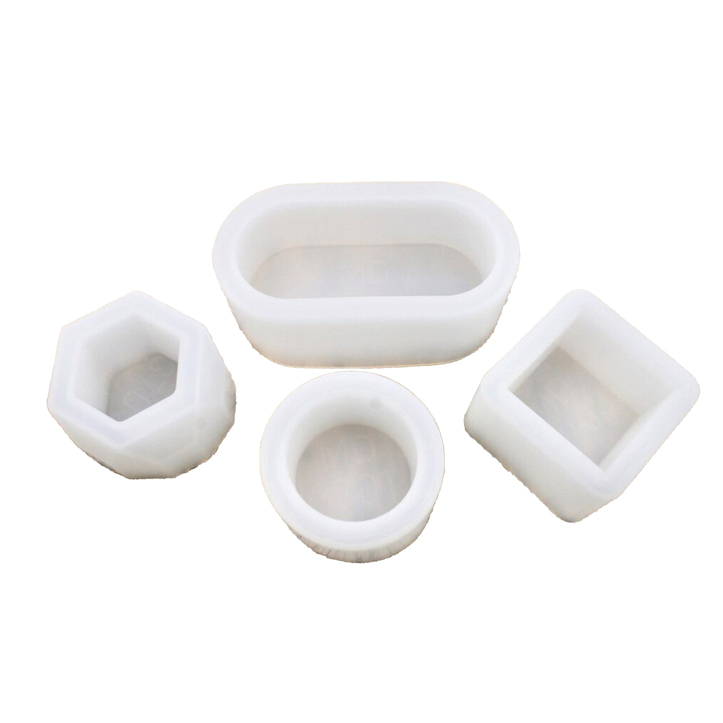 Set of four white silicone molds on a white background