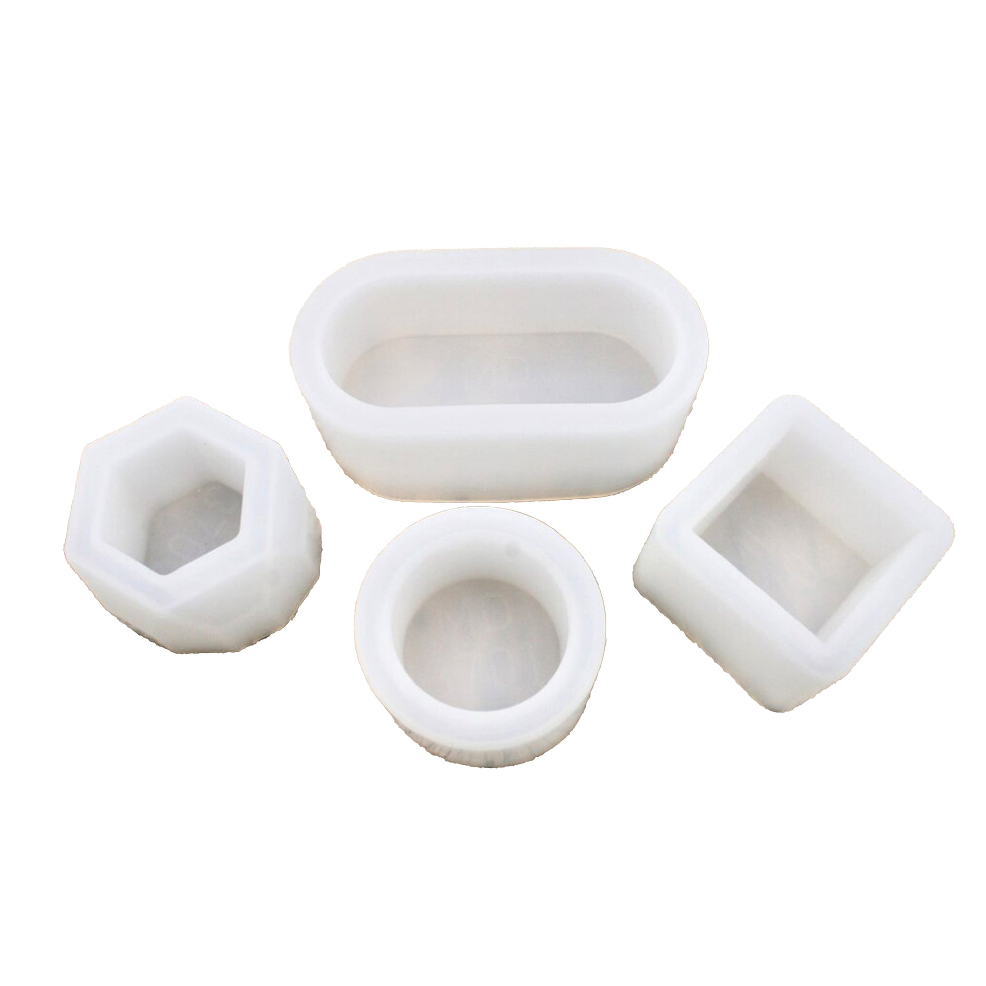 Set of four white silicone molds on a white background