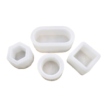 Set of four white silicone molds on a white background